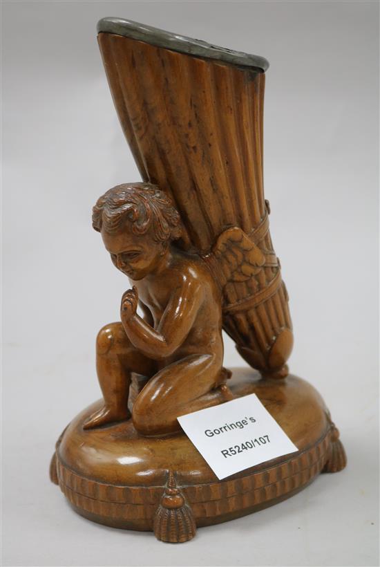 A 19th century quill or spill holder, carved with winged amorini 19cm.